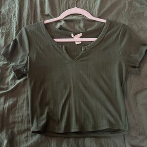 A medium in green crop shirt